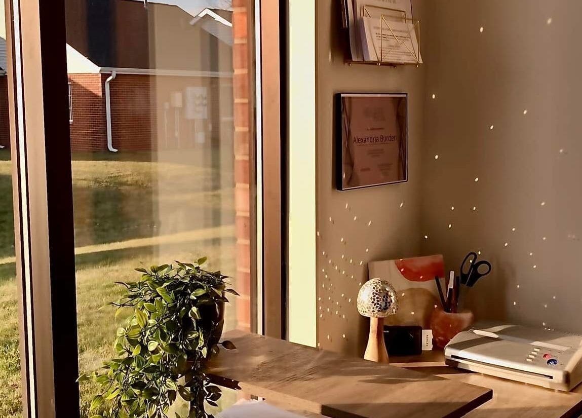 Cozy corner at Ebb and Flow Studio IL, Peru, Illinois, with window view and tidy desk.