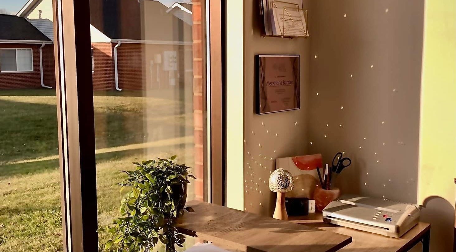 Cozy corner at Ebb and Flow Studio IL, Peru, Illinois, with window view and tidy desk.