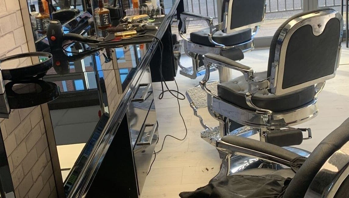 Modern barber chairs and tools at Fade and Blade, Coventry, England, GB, reflecting a sleek salon interior.