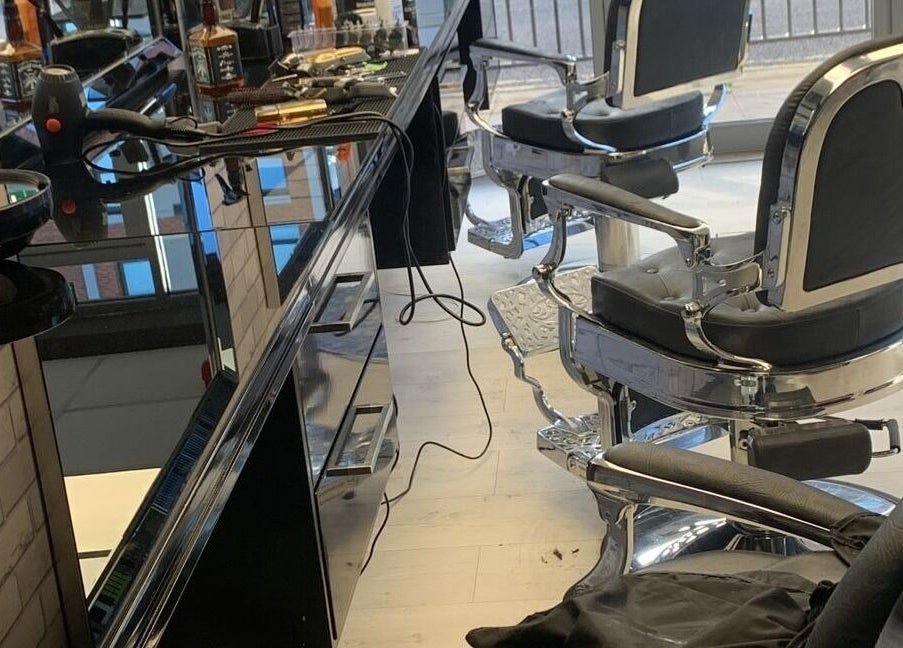 Modern barber chairs and tools at Fade and Blade, Coventry, England, GB, reflecting a sleek salon interior.