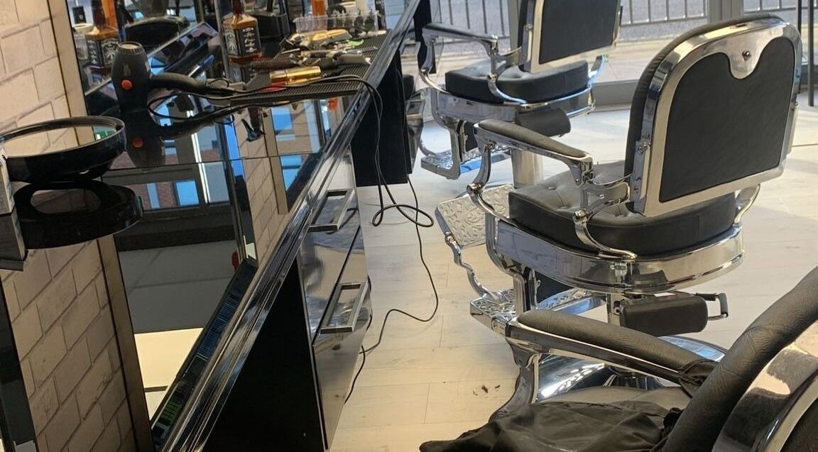 Modern barber chairs and tools at Fade and Blade, Coventry, England, GB, reflecting a sleek salon interior.