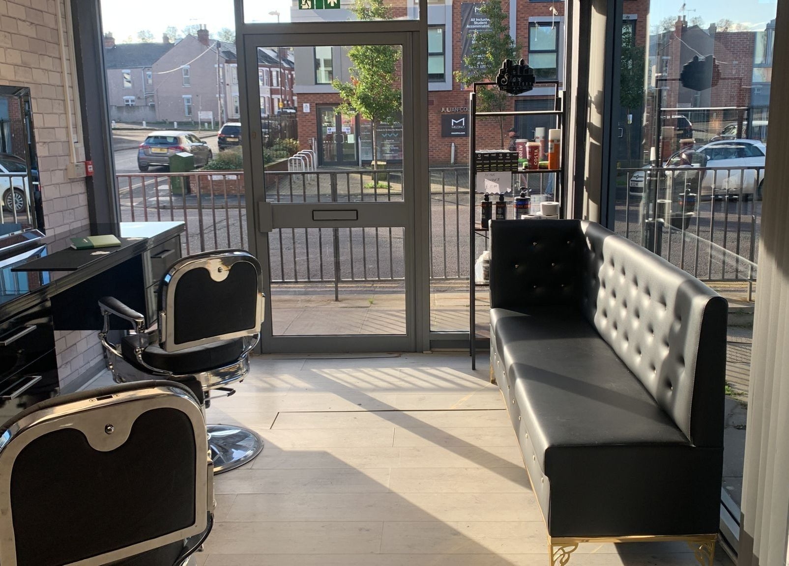 Bright, modern interior of Fade and Blade salon in Coventry, England, GB with stylish seating and barber chairs.