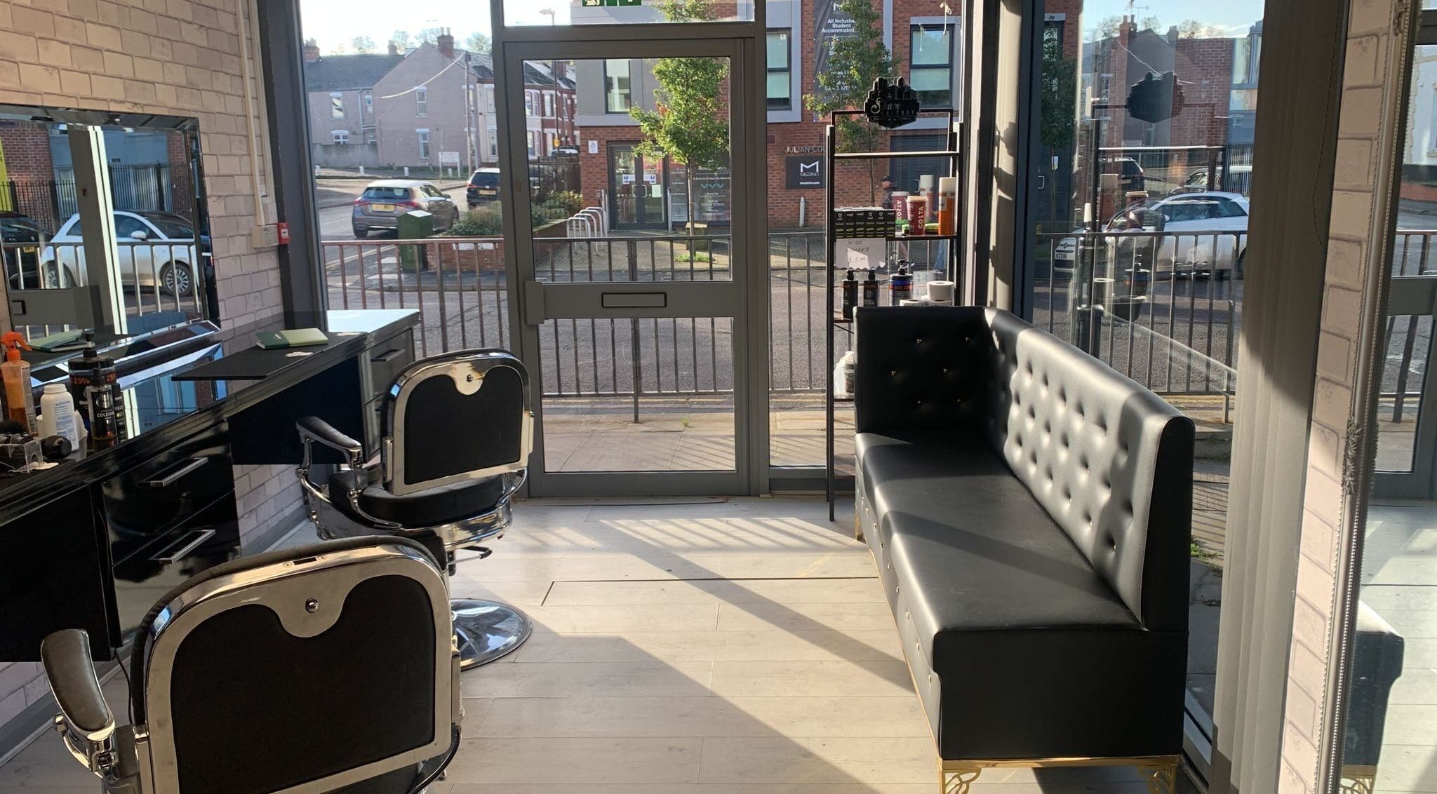 Bright, modern interior of Fade and Blade salon in Coventry, England, GB with stylish seating and barber chairs.