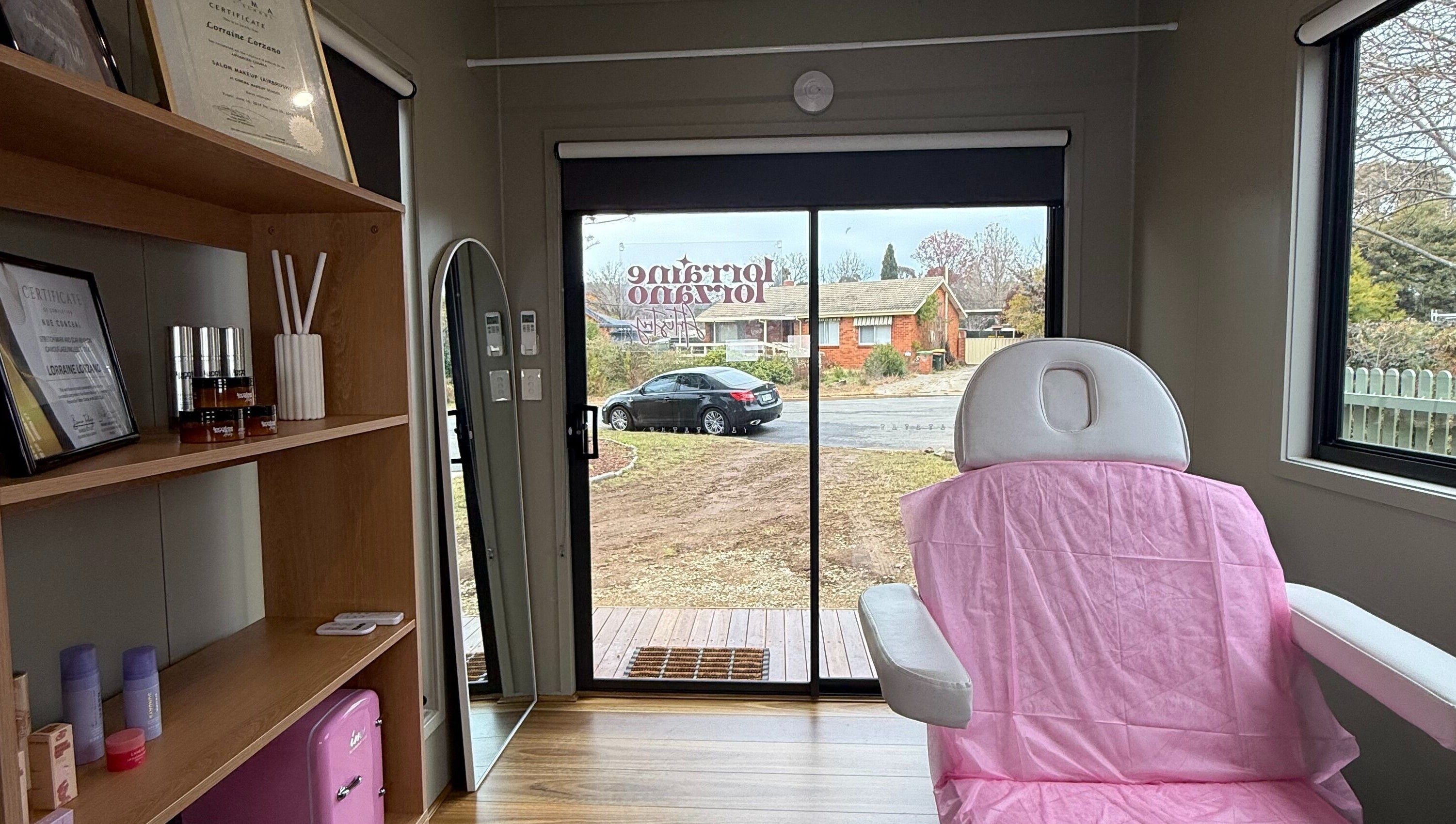 Cozy interior of Lorraine Lorzano Artistry in Downer, ACT, AU showcasing a treatment chair and skincare products.