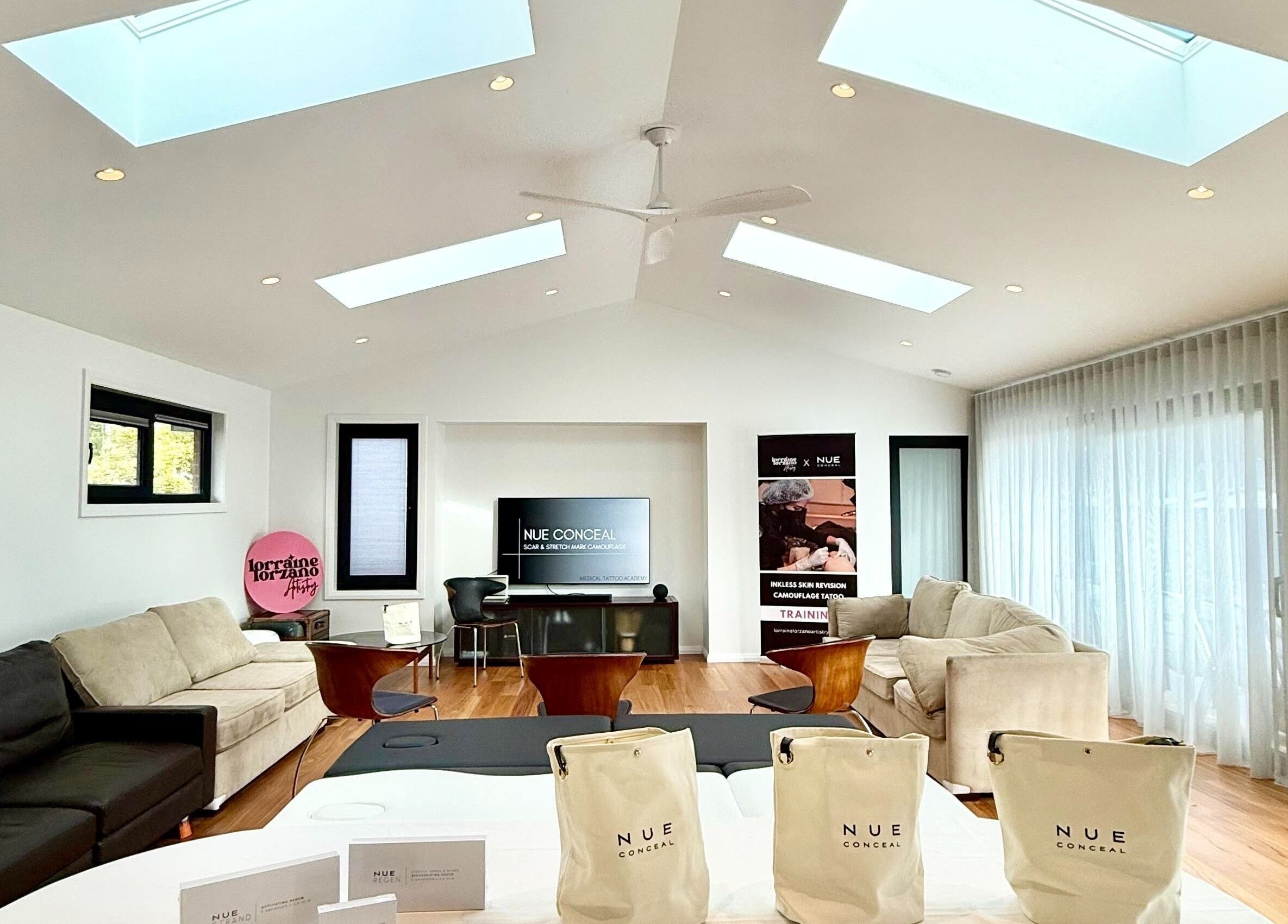 Spacious, well-lit lounge at Lorraine Lorzano Artistry in Downer, ACT, AU with cozy seating and modern decor.