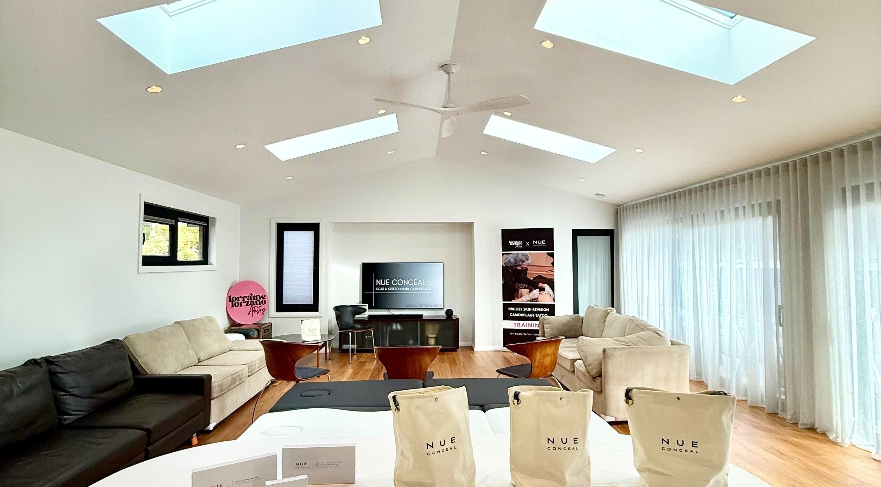 Spacious, well-lit lounge at Lorraine Lorzano Artistry in Downer, ACT, AU with cozy seating and modern decor.