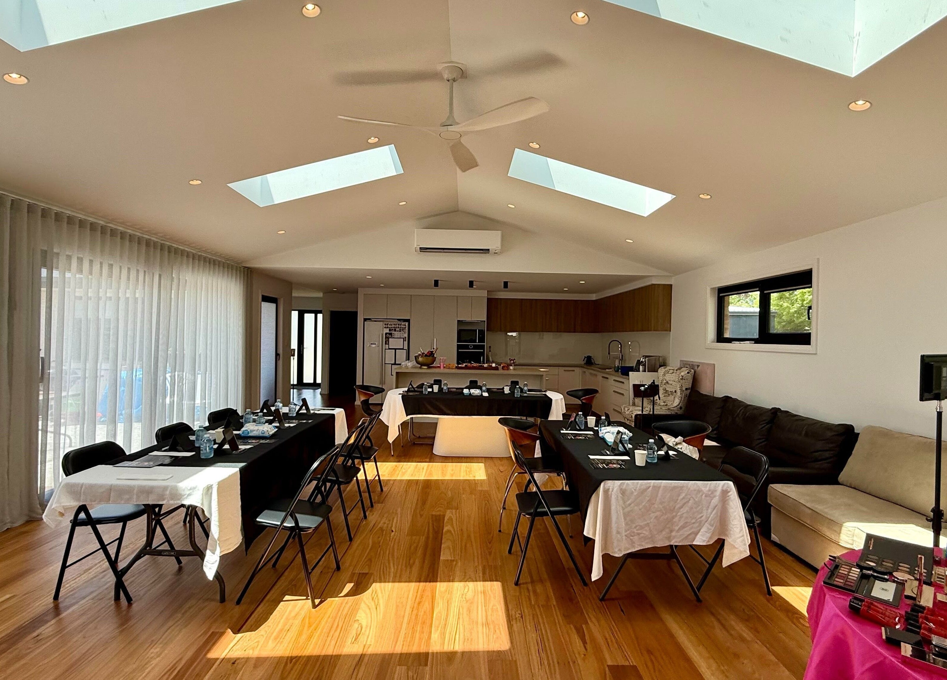 Spacious interior of Lorraine Lorzano Artistry in Downer, ACT, AU with tables set for beauty sessions.