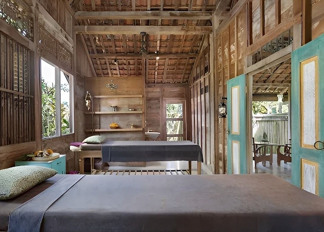 Cozy treatment room at 1919 Spa in Bali, Bali, ID with wooden decor and natural light.