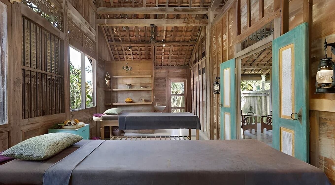 Cozy treatment room at 1919 Spa in Bali, Bali, ID with wooden decor and natural light.