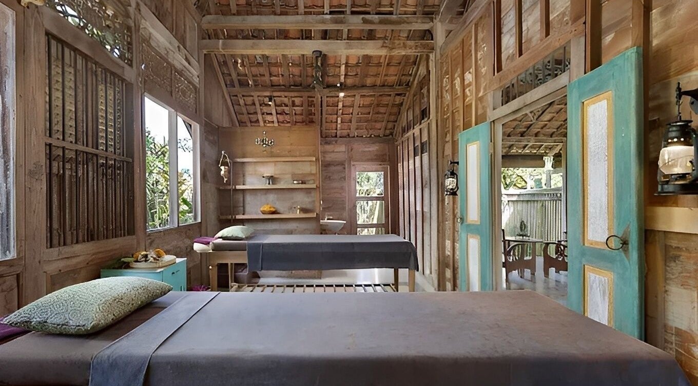 Cozy treatment room at 1919 Spa in Bali, Bali, ID with wooden decor and natural light.