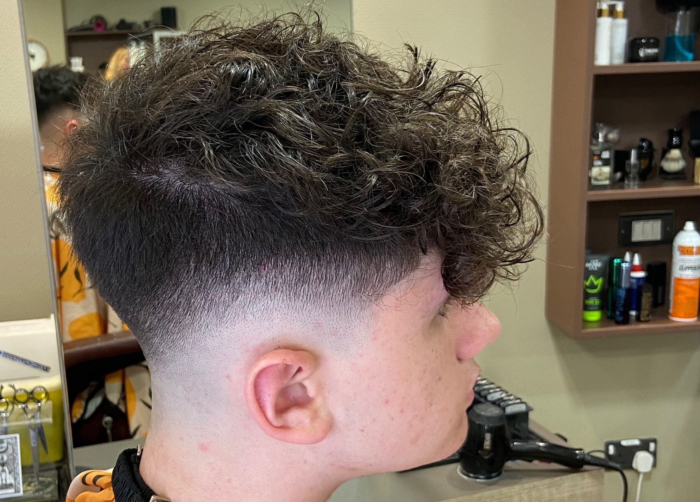 Curly fade haircut styled at Jay’s Barbering at Beaujolais Hair, Dunstable, England, GB.