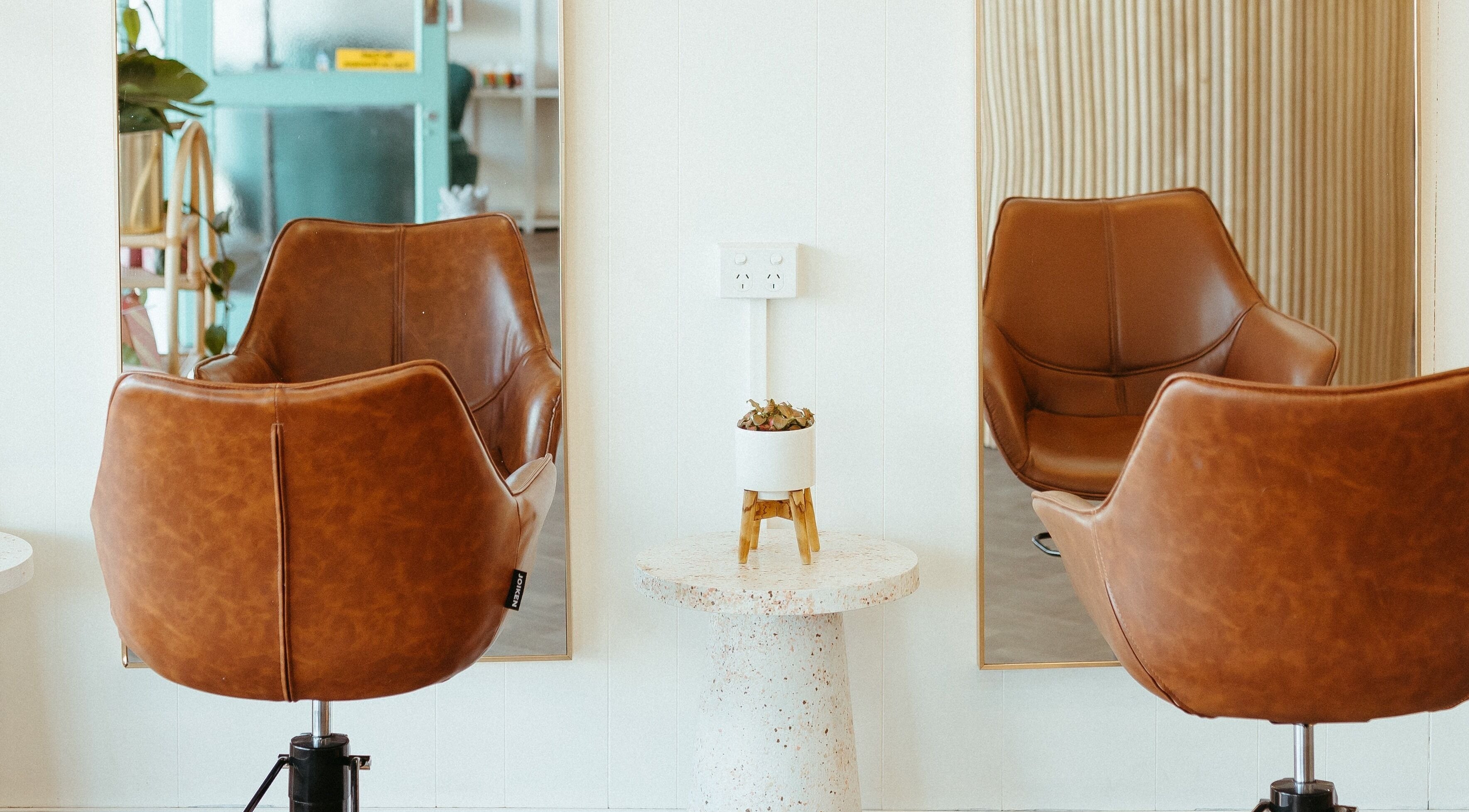 Stylish salon chairs at Aveta Hair And Body, Port Noarlunga, SA, AU, offering luxury hair styling.