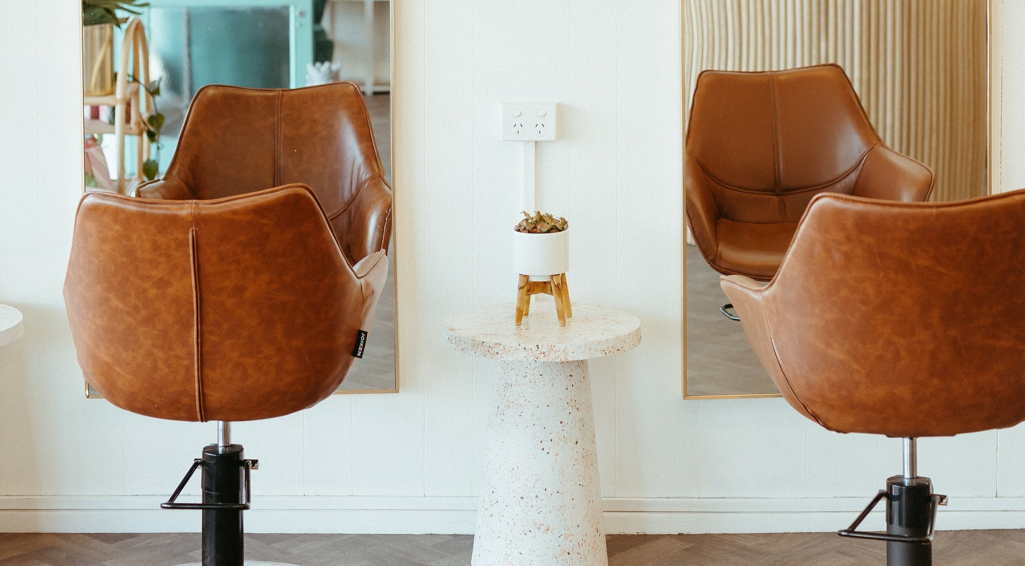 Modern brown salon chairs at Aveta Hair And Body, Port Noarlunga, SA, AU embody luxury and style.