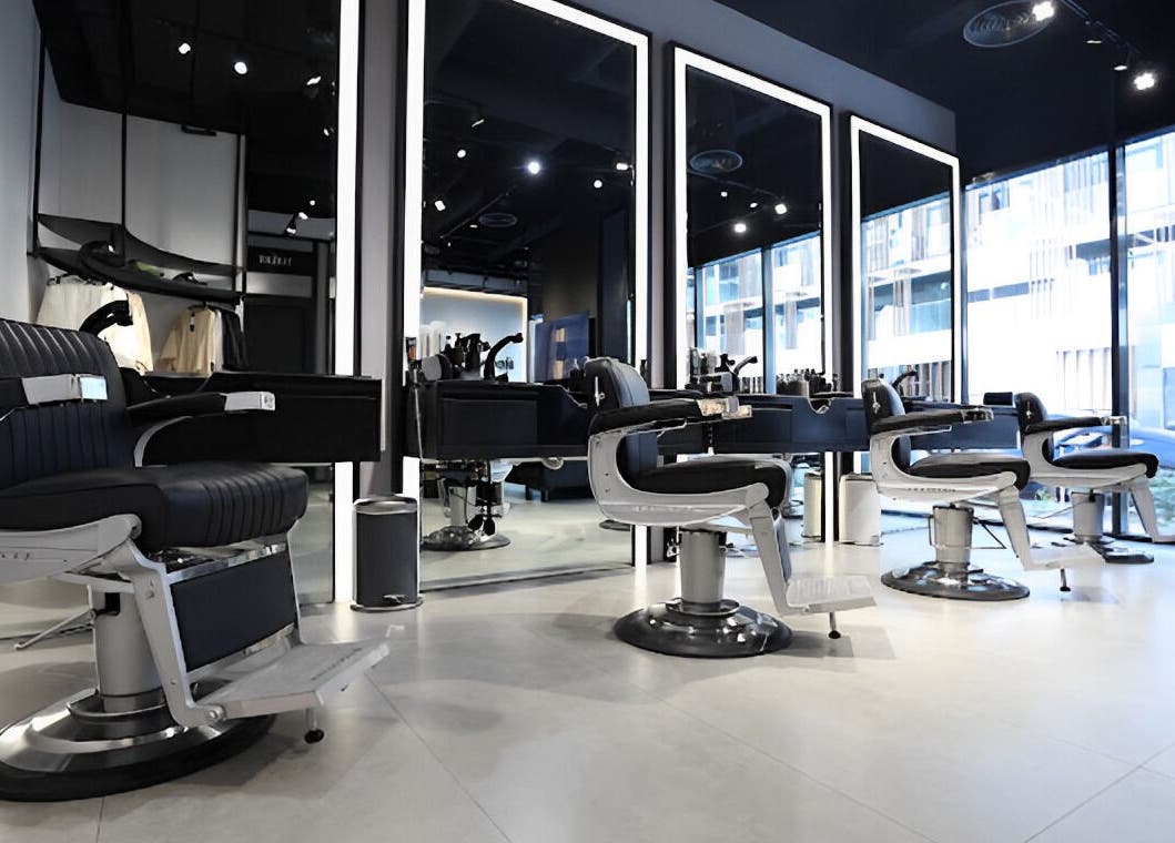 Spacious interior of The Hound DXB barbershop in Dubai with sleek modern styling chairs.