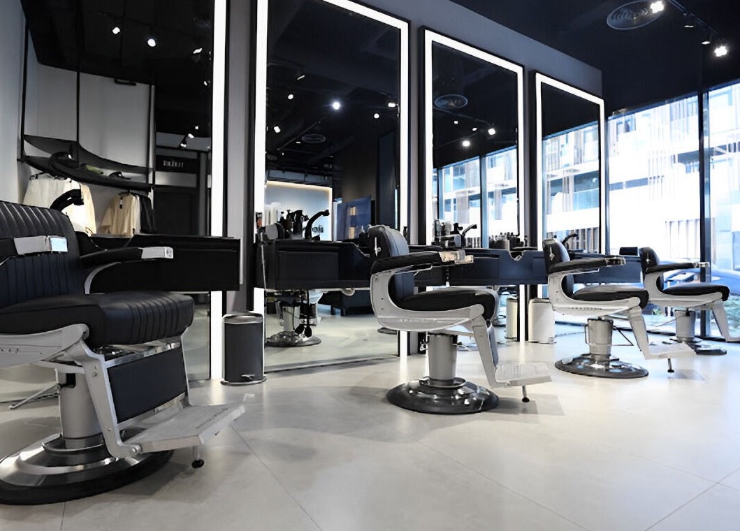Spacious interior of The Hound DXB barbershop in Dubai with sleek modern styling chairs.