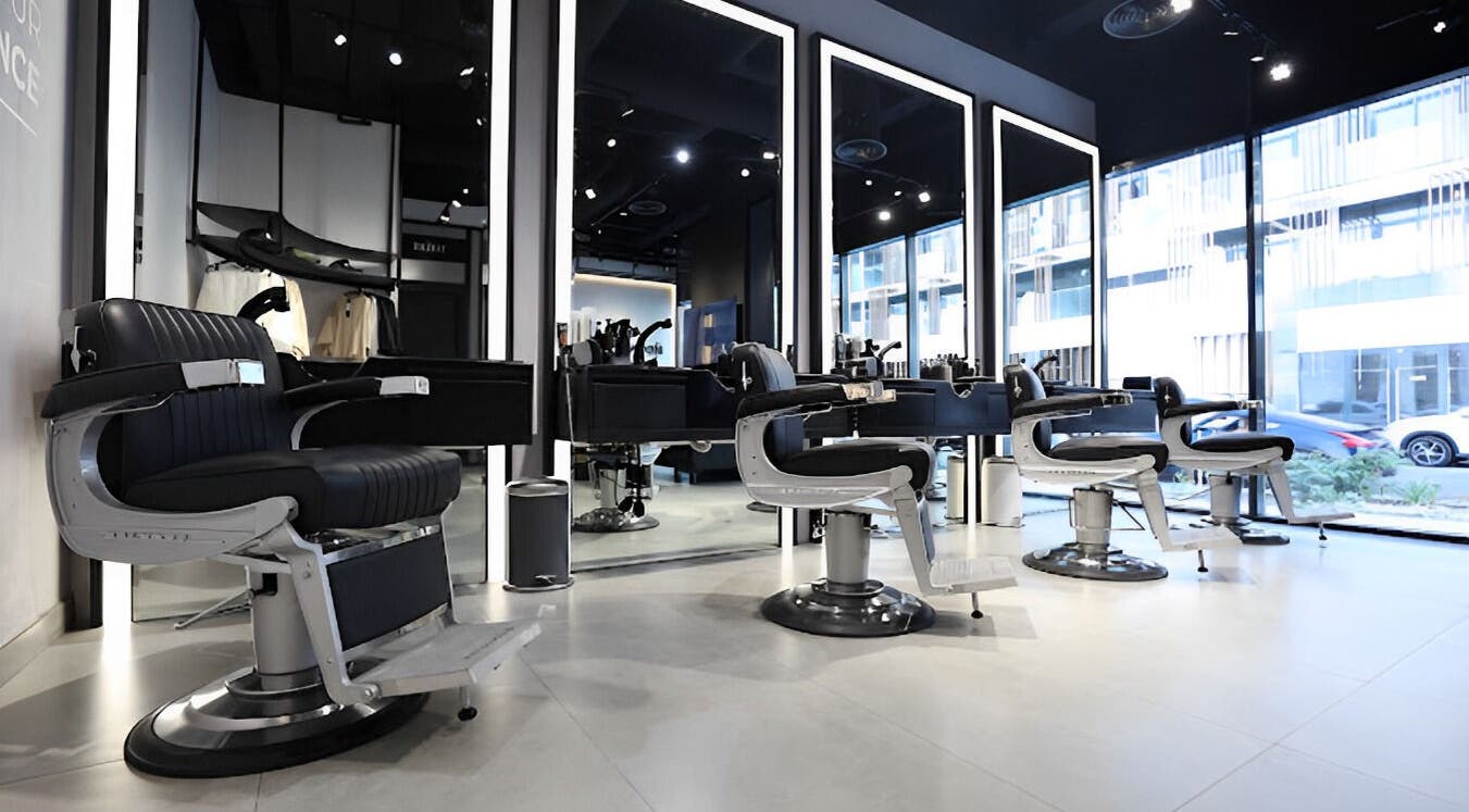 Spacious interior of The Hound DXB barbershop in Dubai with sleek modern styling chairs.