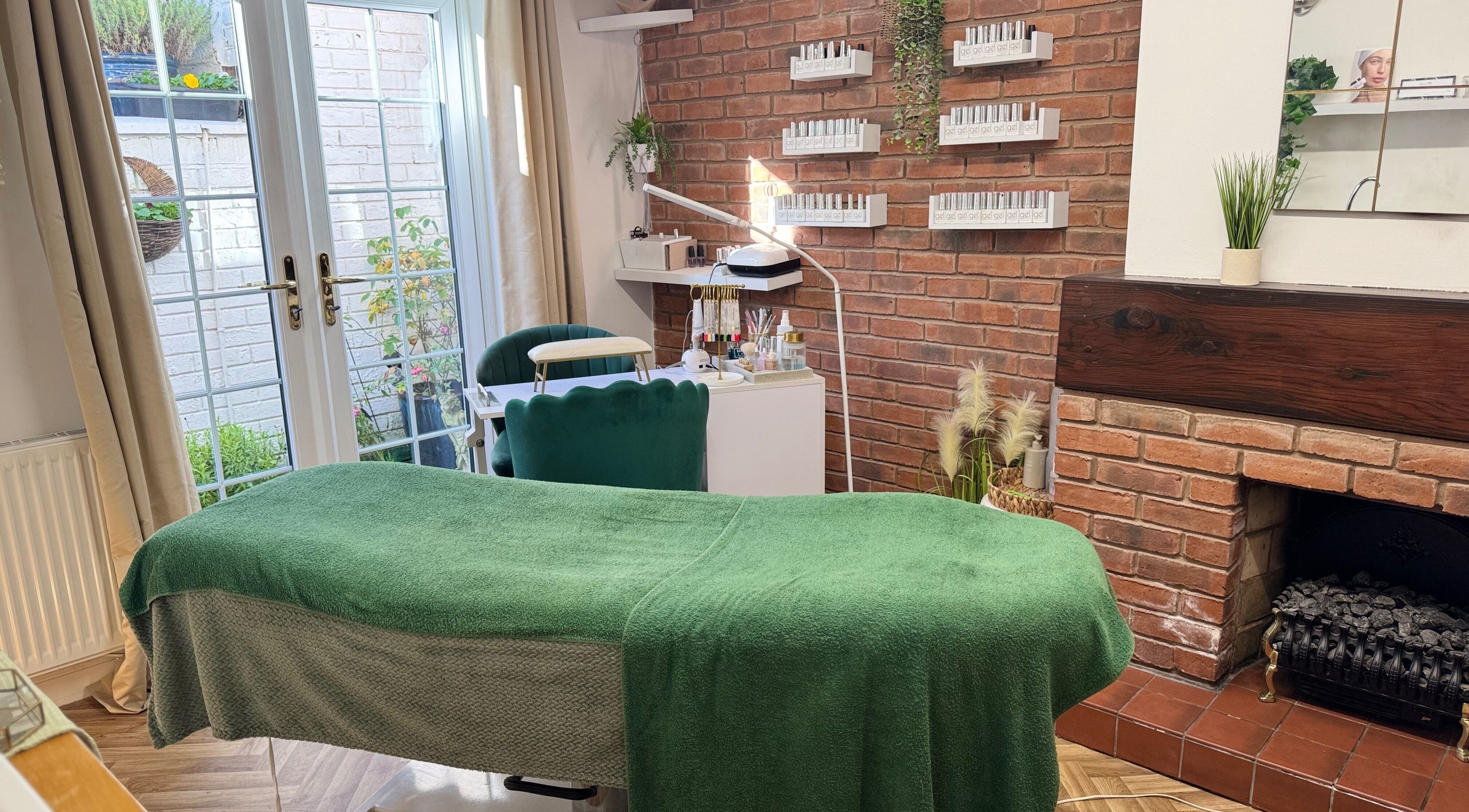 Relaxing treatment room at Beauty By Holly, Abberley, England, GB with lush greenery and soft lighting.