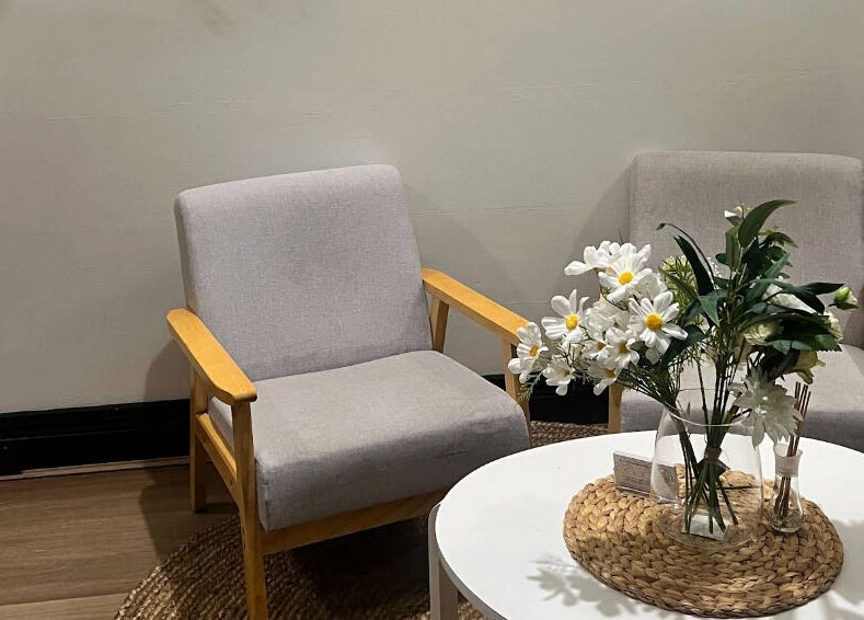 Cozy seating at Thai Oasis Lifestyle Massage & Spa, Stanmore, New South Wales, AU, with elegant floral decor.