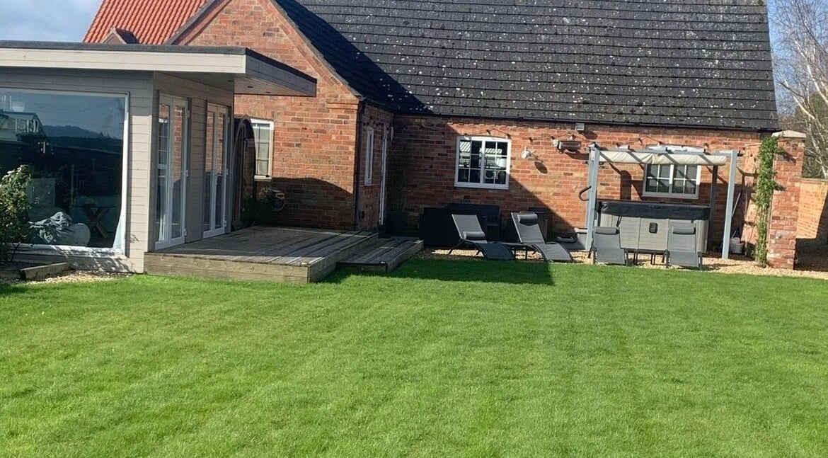 Lush garden at Hydro Health & Beauty Harby, Lincoln, England, GB with spa and seating area.