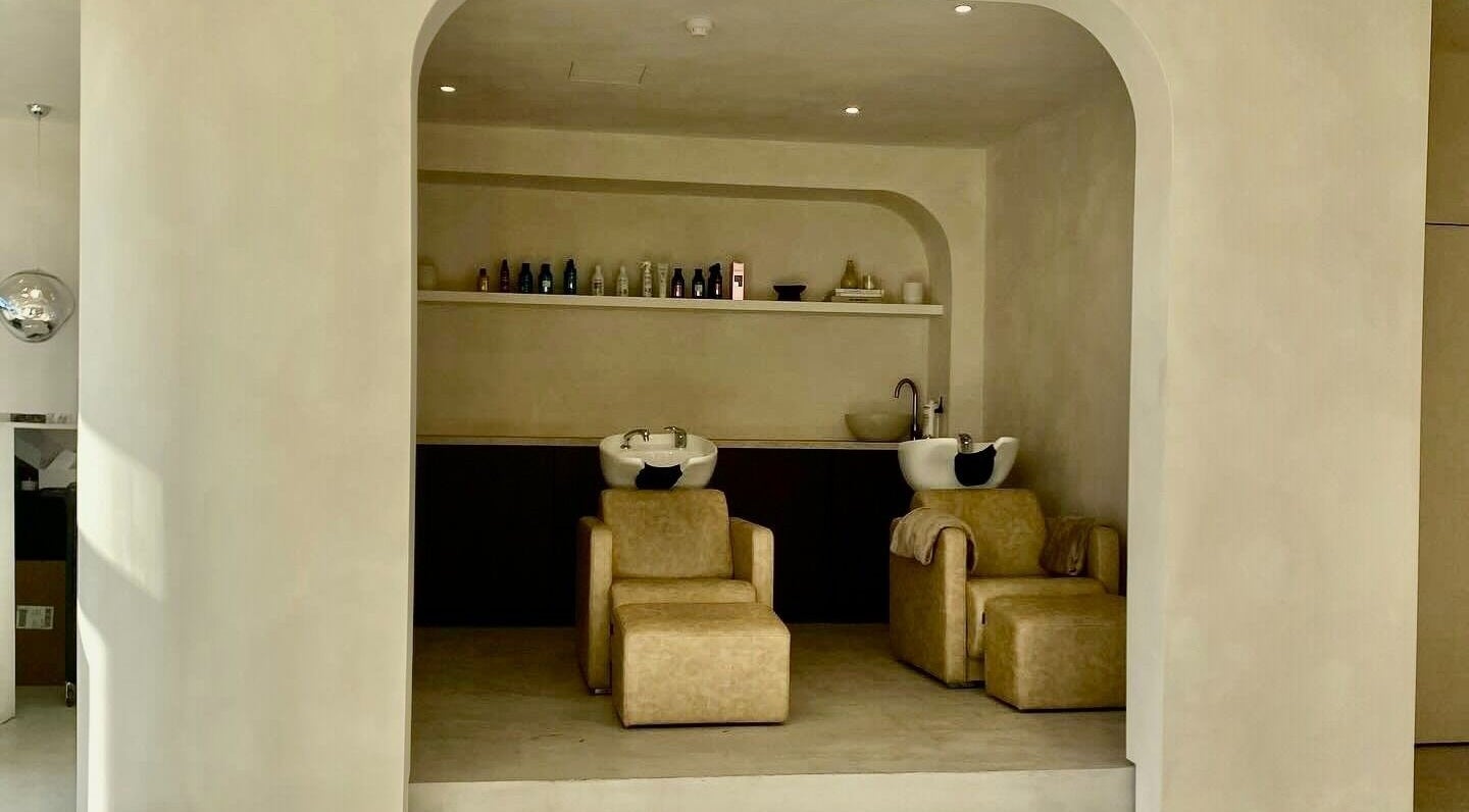 Stylish wash area at ZJB Lashes, Southampton, England, GB, featuring modern sinks and plush chairs.