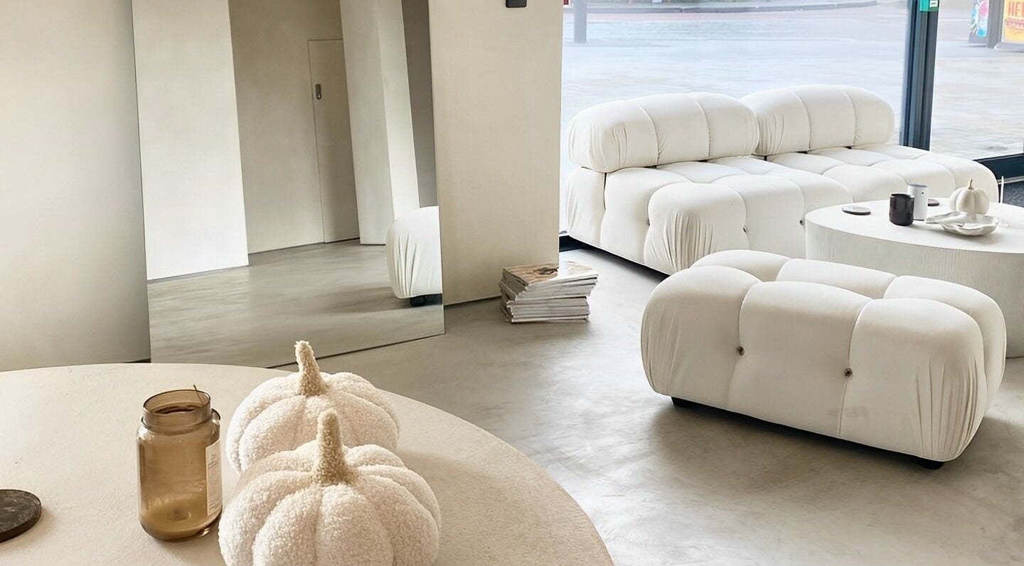Modern, cozy lounge area at ZJB Lashes, Southampton, England, GB with plush white seating and chic decor.