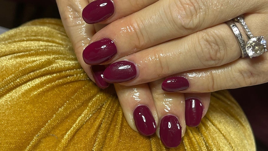 Manicured nails with rich burgundy polish at Cuticles and Co, Marple, England, GB.