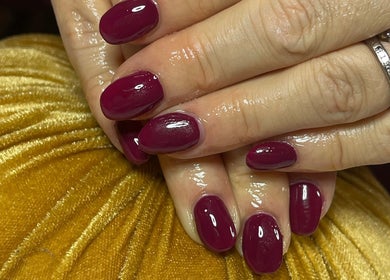 Manicured nails with rich burgundy polish at Cuticles and Co, Marple, England, GB.