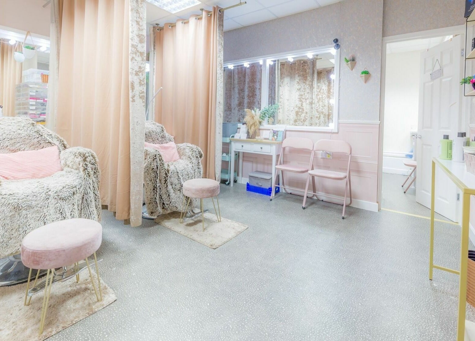 Elegant beauty studio interior at Changing Faces Studio, Exeter. Plush chairs and chic decor enhance relaxation.
