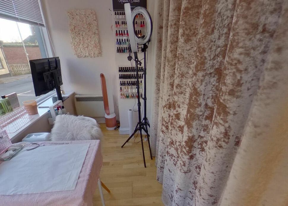 Bright nail area at Changing Faces Studio, Exeter, England, GB, featuring modern decor and nail polish display.