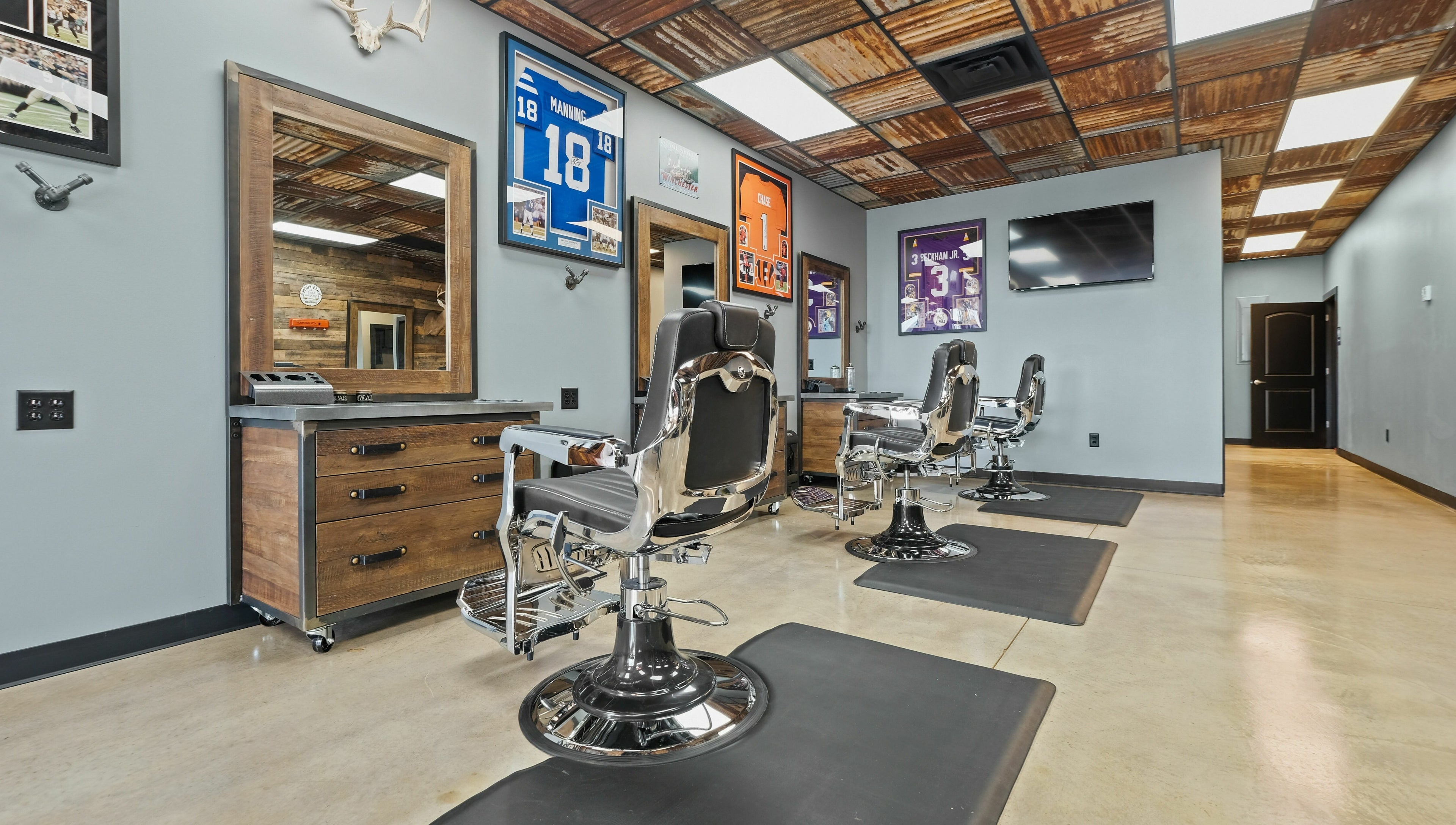 Modern barber chairs in Mancave Cenla, Pineville, Louisiana, US showcasing a stylish and inviting interior.