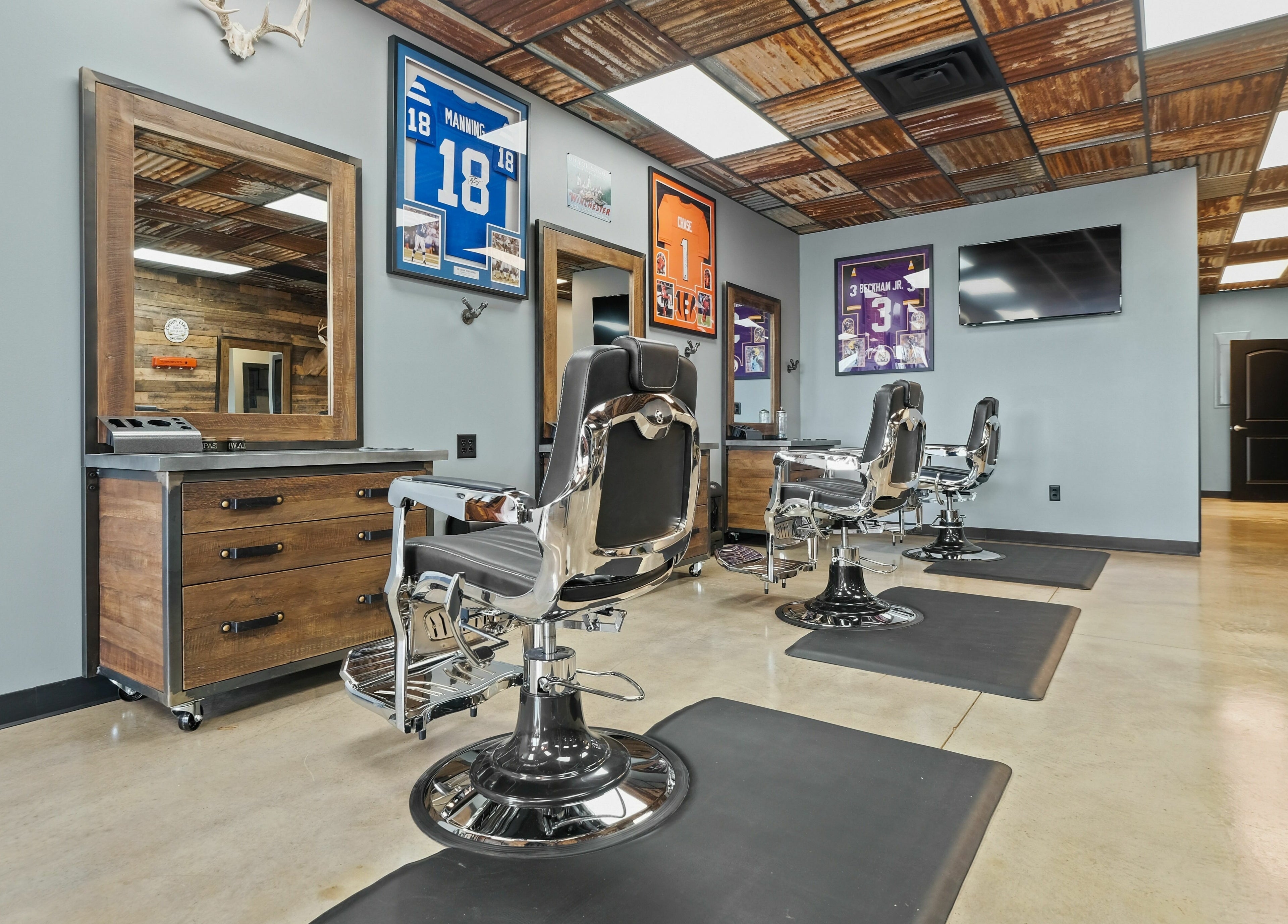 Modern barber chairs in Mancave Cenla, Pineville, Louisiana, US showcasing a stylish and inviting interior.
