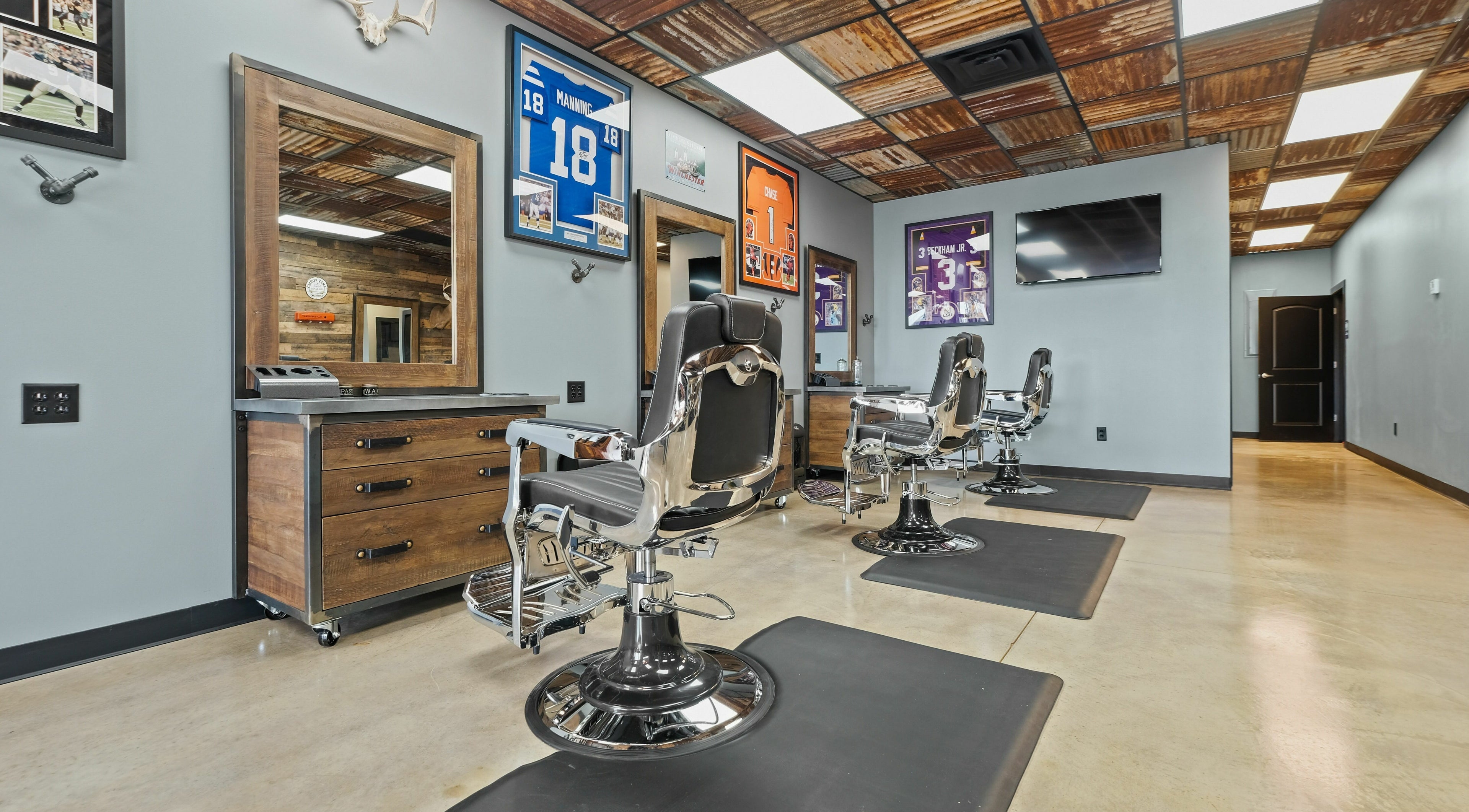 Modern barber chairs in Mancave Cenla, Pineville, Louisiana, US showcasing a stylish and inviting interior.