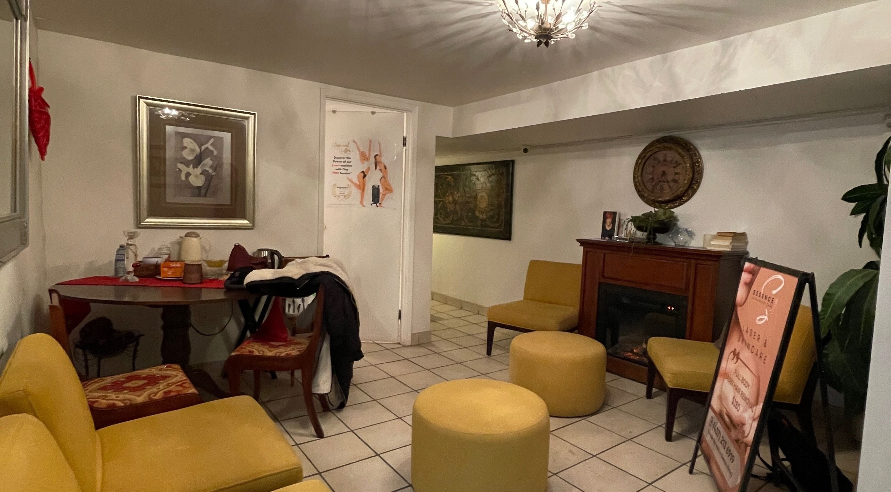 Lounge area at Essence Laser and Skin Care in Toronto, Ontario, CA with yellow seating and decor.