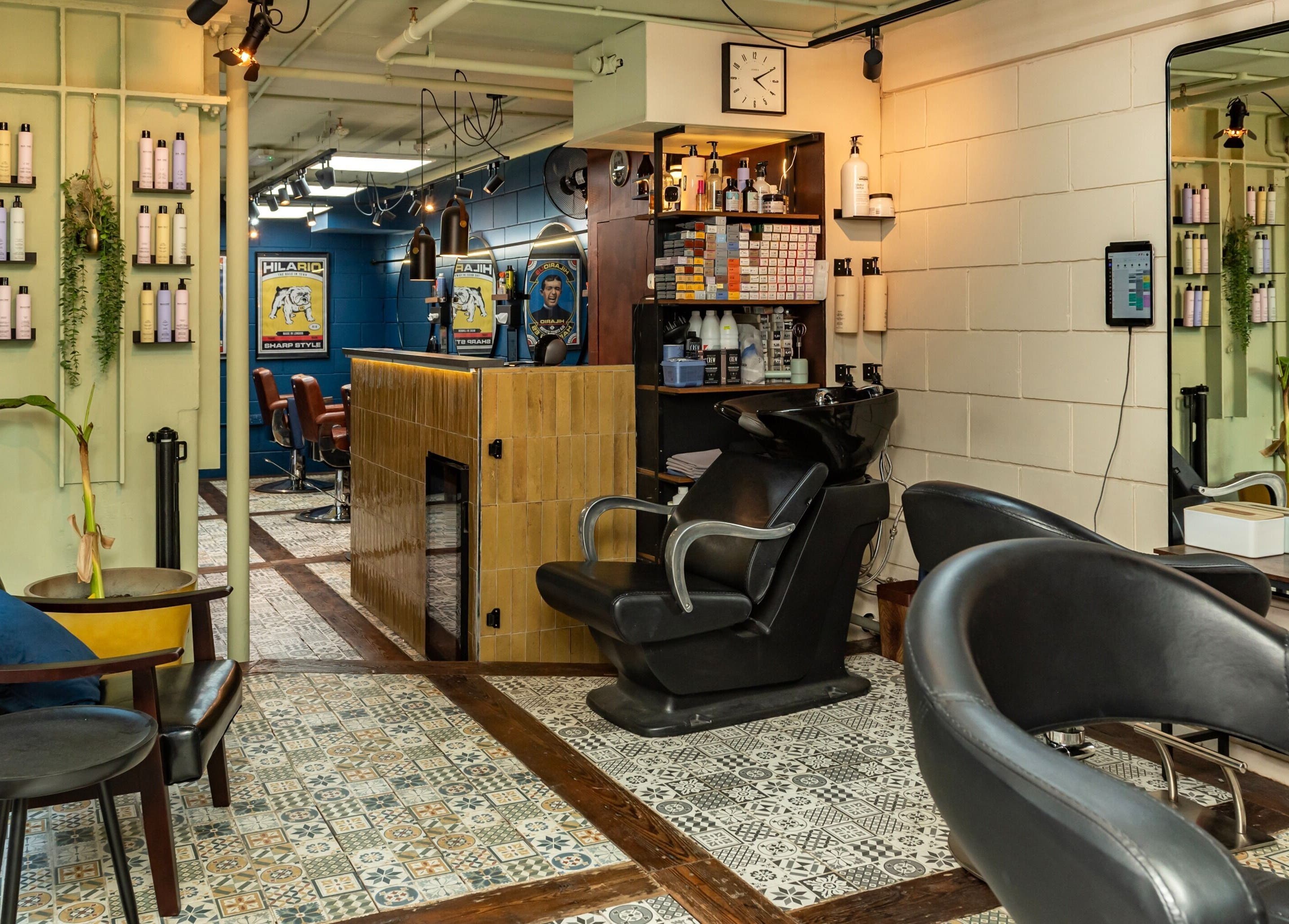 Interior of Hilario beauty salon in London, England, GB, featuring stylish chairs, products, and vibrant decor.