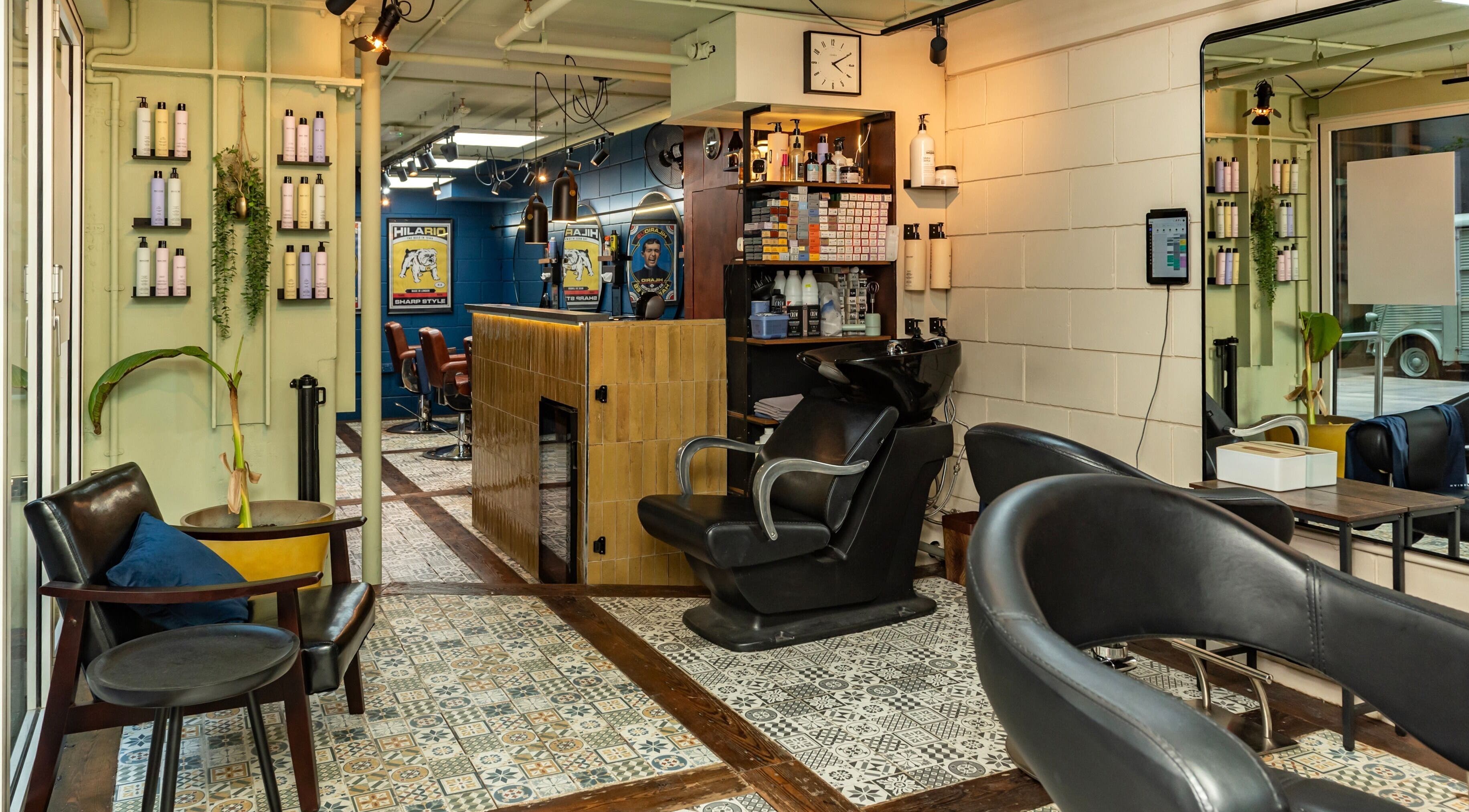 Interior of Hilario beauty salon in London, England, GB, featuring stylish chairs, products, and vibrant decor.