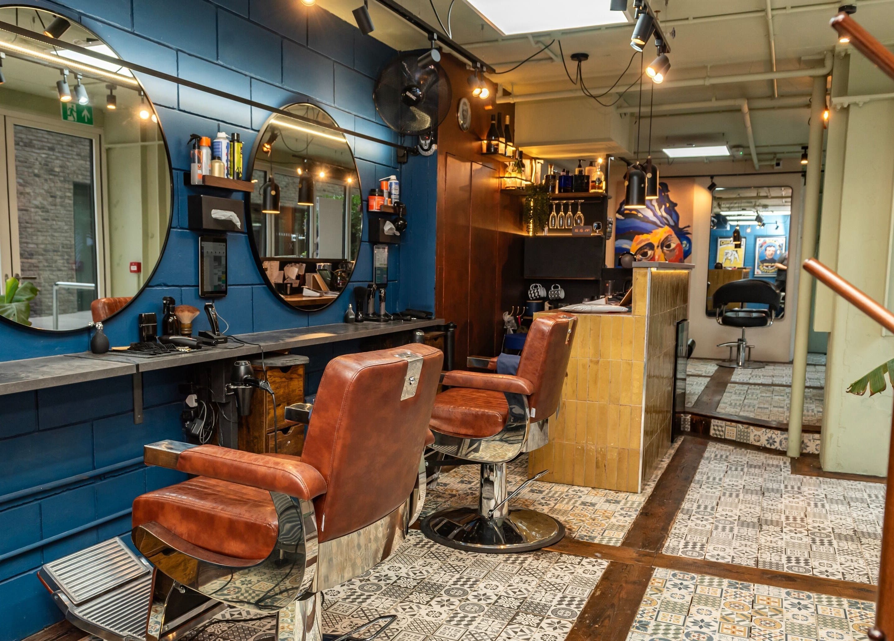 Hilario salon's chic interior with leather chairs and mirrors in London, England, GB.