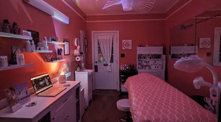 Cozy skincare room at Mud and Lotus Skincare, Burnsville, North Carolina, US, with ambient lighting and treatment bed.