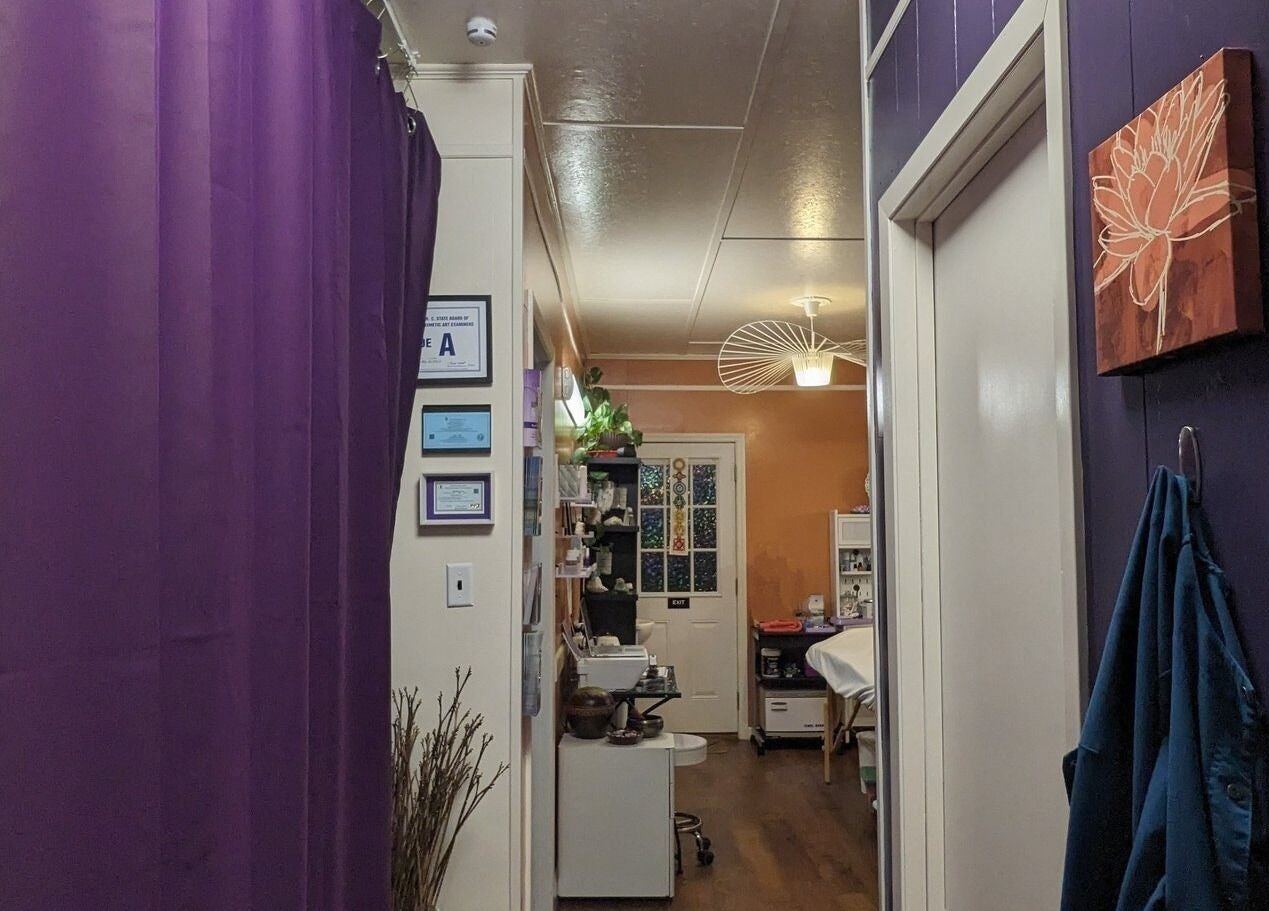 Cozy corridor at Mud and Lotus Skincare in Burnsville, North Carolina, US with warm lighting and purple accents.