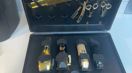 Professional barber tools at Tunechi the Barber, Coventry, England, GB. Premium clippers and scissors displayed.