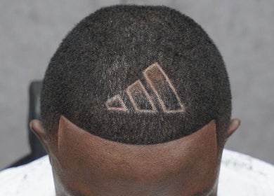 Unique haircut design at Tunechi the Barber in Coventry, England, GB, showcasing creative barbering skills.