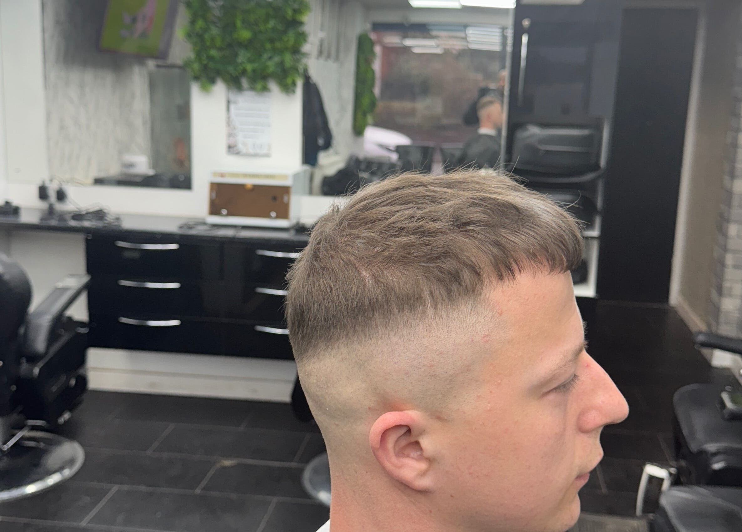 Modern fade hairstyle at Tunechi the Barber, Coventry, England, GB. Professional salon interior visible.