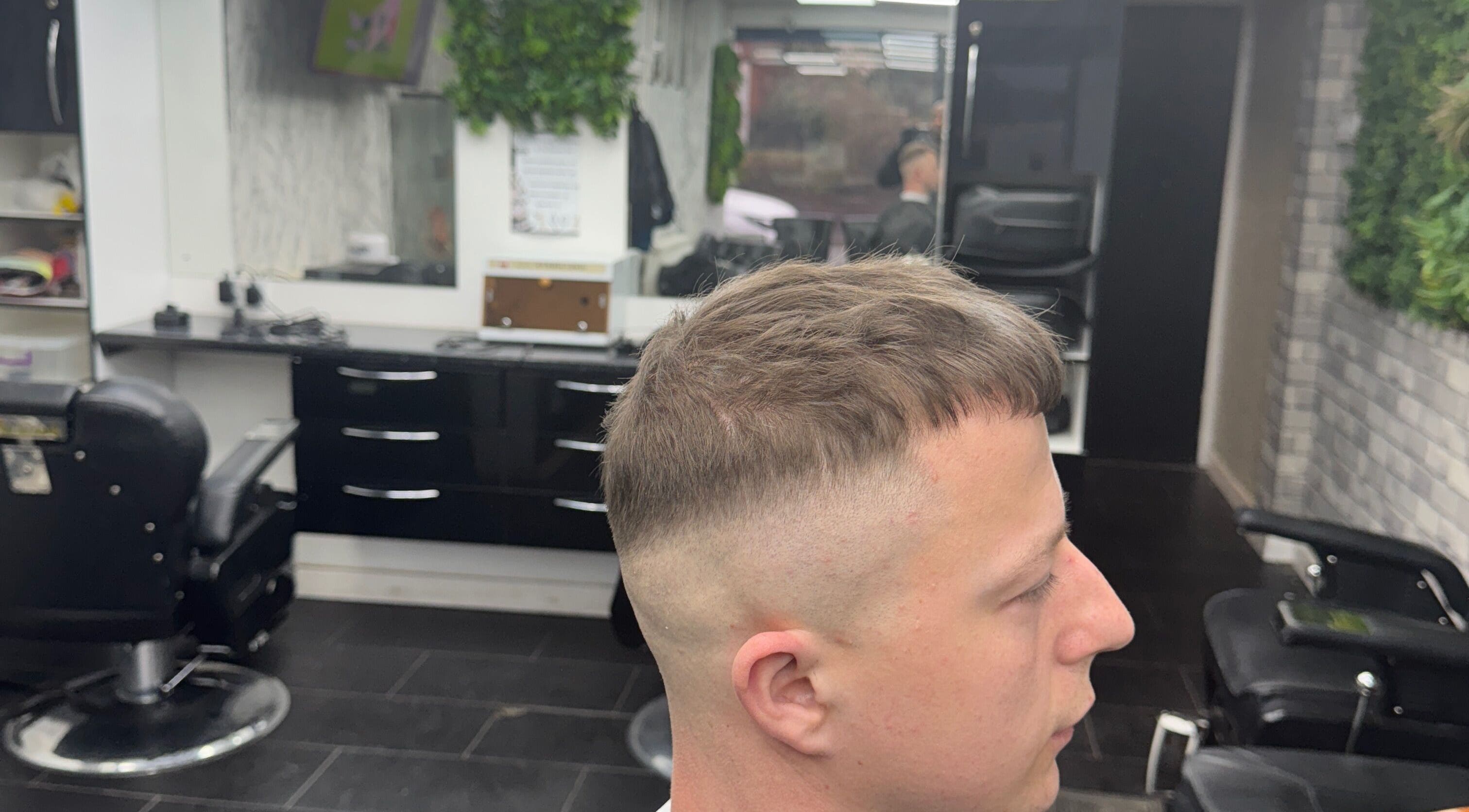 Modern fade hairstyle at Tunechi the Barber, Coventry, England, GB. Professional salon interior visible.