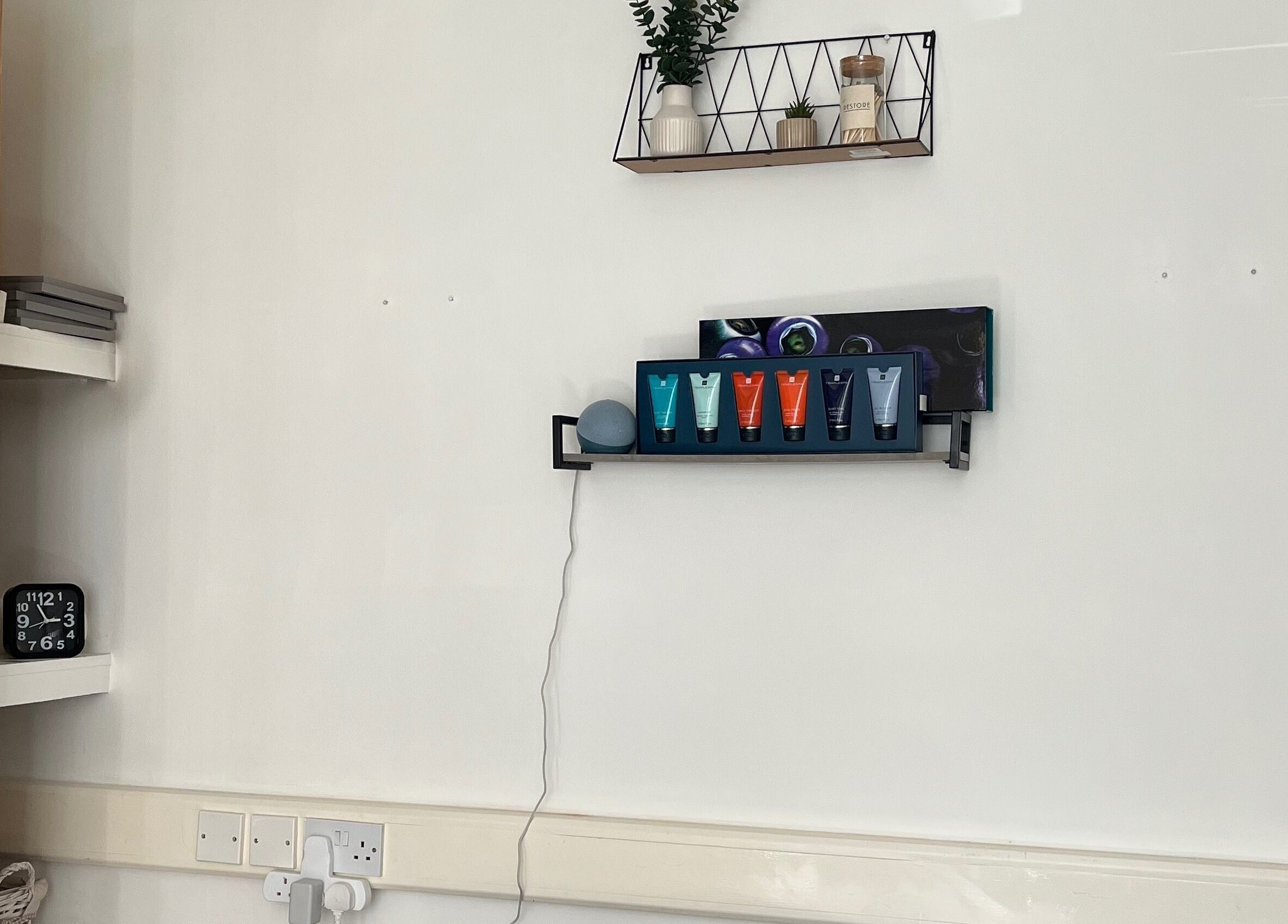Modern shelf at Jojo May Wellbeing, Redditch, England, GB, featuring skincare products and decor.