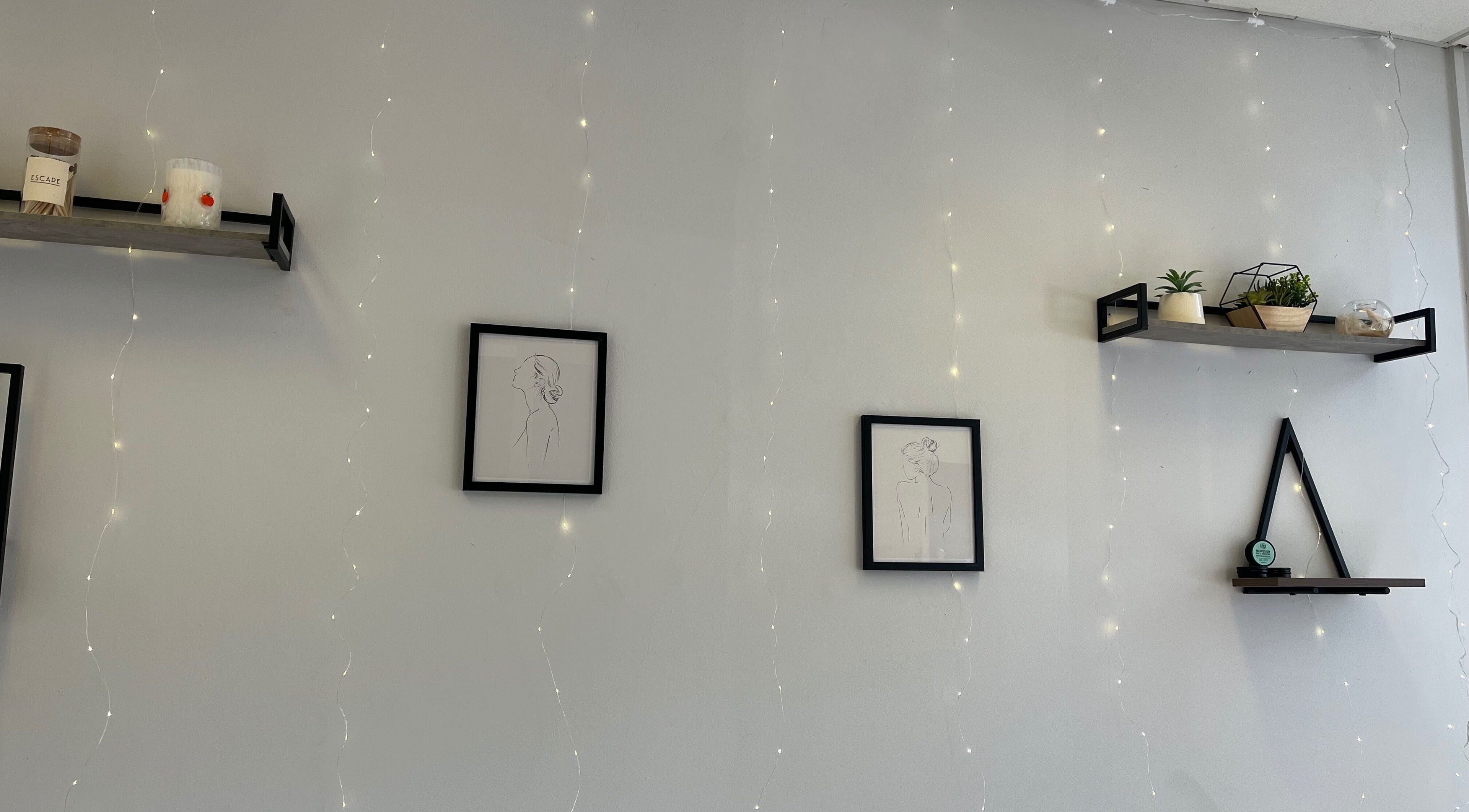 Minimalist wall art and shelves at Jojo May Wellbeing in Redditch, England, GB create a calming ambiance.
