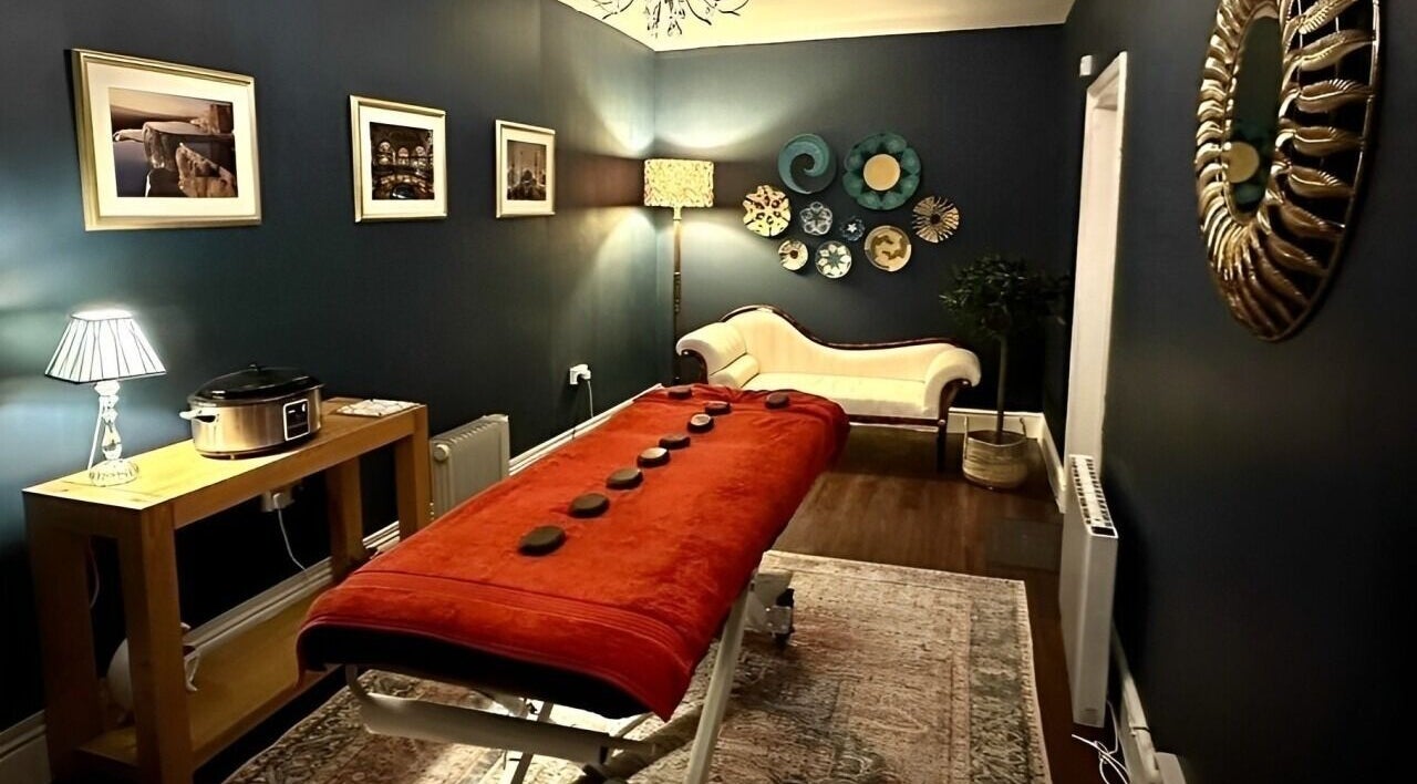 Elegant massage room at Ottoman Retreat Ltd., Warrington, England, GB with warm lighting and decor.