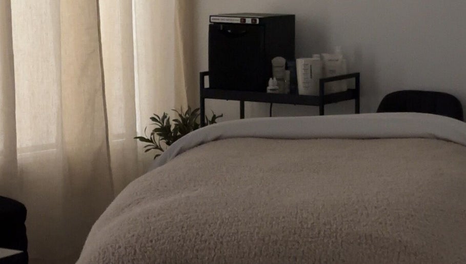 Tranquil spa room at Esthetics by Tay in Newport Beach, California, US, with cozy treatment bed.