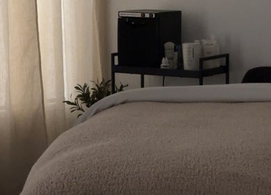 Tranquil spa room at Esthetics by Tay in Newport Beach, California, US, with cozy treatment bed.