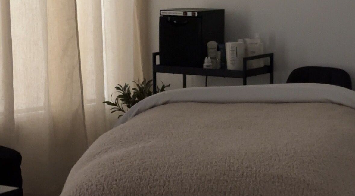 Tranquil spa room at Esthetics by Tay in Newport Beach, California, US, with cozy treatment bed.