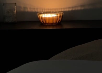 Warm candlelight ambiance at Esthetics by Tay, Newport Beach, California, US creates a relaxing spa atmosphere.