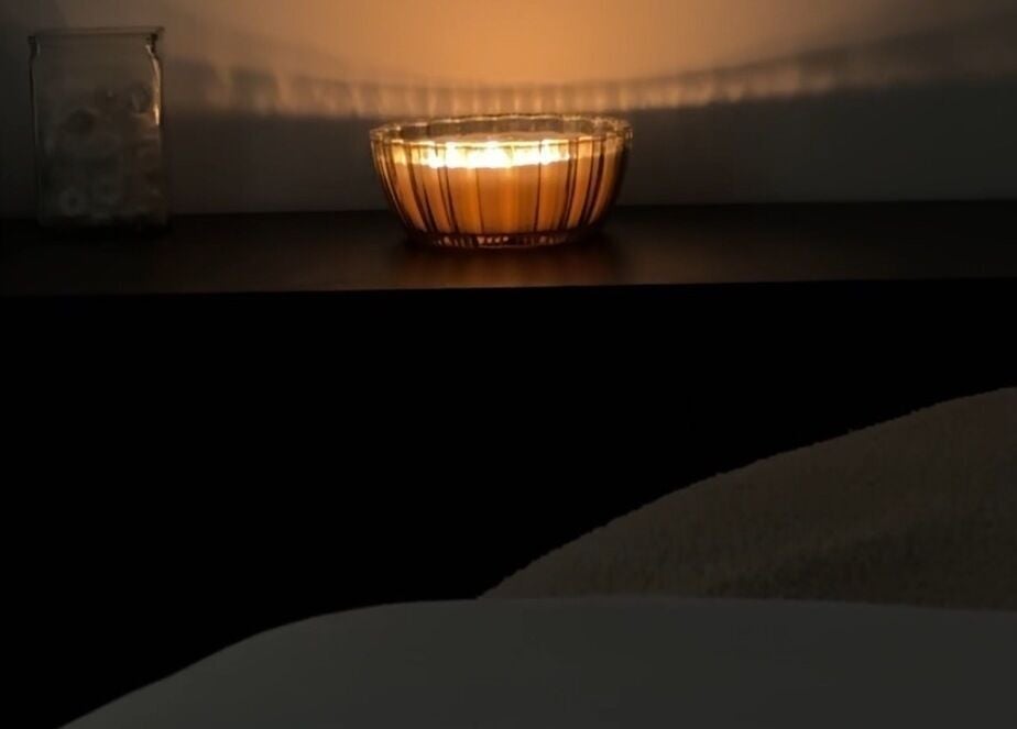 Warm candlelight ambiance at Esthetics by Tay, Newport Beach, California, US creates a relaxing spa atmosphere.